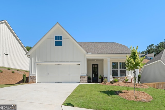 view of front of property with concrete driveway, board and batten siding, and brick siding