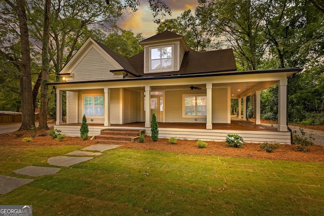 farmhouse-style home featuring covered porch and a front lawn