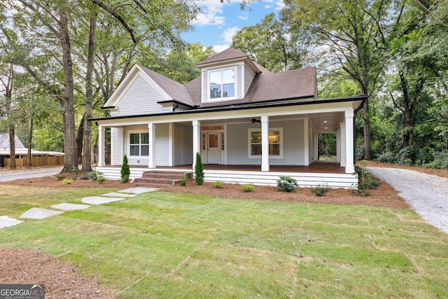 view of front of house with covered porch and a front yard