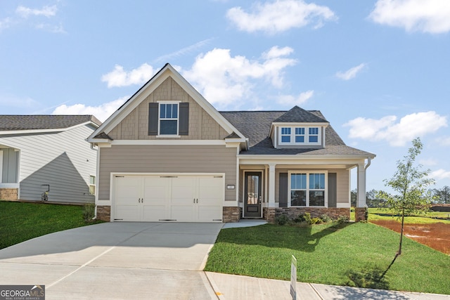 craftsman inspired home featuring driveway, a garage, and a front yard