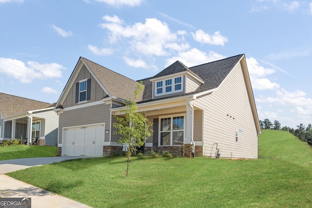 craftsman-style home featuring driveway, a front lawn, an attached garage, and a shingled roof