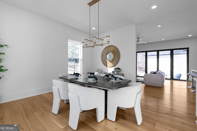 dining area with recessed lighting, baseboards, light wood finished floors, and ceiling fan with notable chandelier