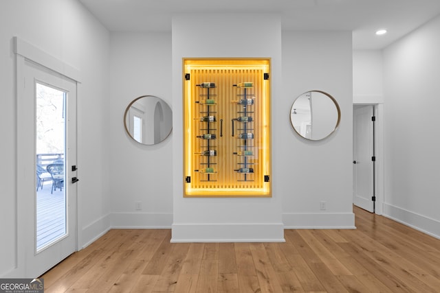 entryway with recessed lighting, light wood-style flooring, and baseboards