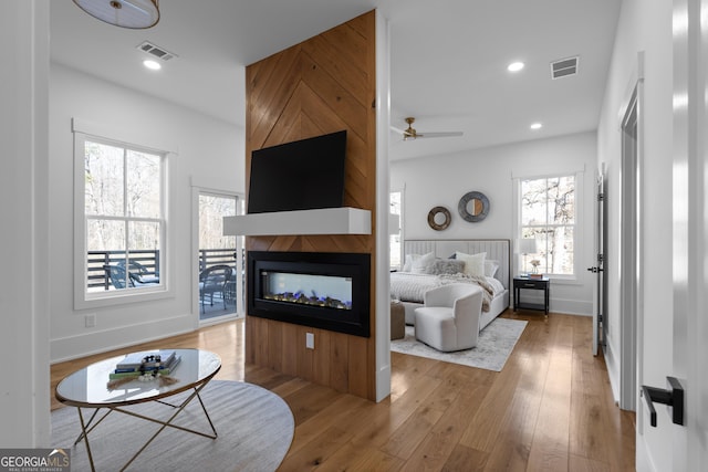 living room featuring hardwood / wood-style flooring, visible vents, and recessed lighting