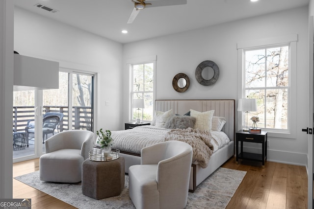 bedroom featuring access to outside, wood-type flooring, visible vents, and recessed lighting