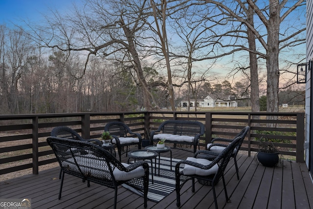 wooden terrace with an outdoor hangout area