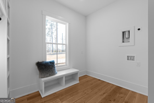 mudroom with a healthy amount of sunlight, light wood-style floors, and baseboards