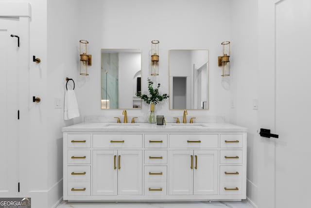 full bath with marble finish floor, an enclosed shower, a sink, and double vanity