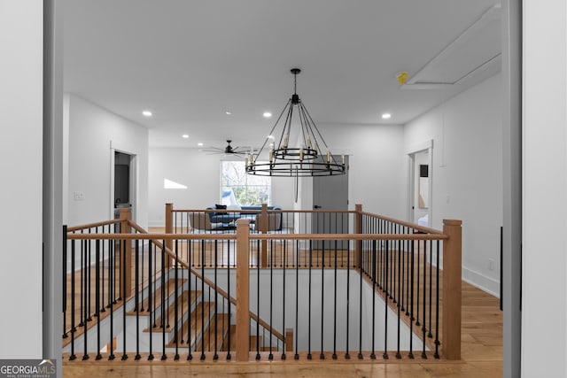 interior space with ceiling fan with notable chandelier, recessed lighting, and wood finished floors