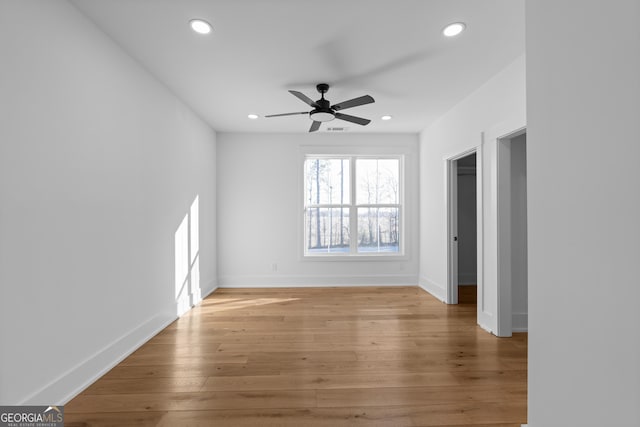 interior space with light wood-style floors, baseboards, a ceiling fan, and recessed lighting