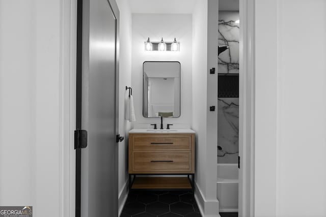 bathroom featuring baseboards, vanity, shower / tub combination, and tile patterned floors