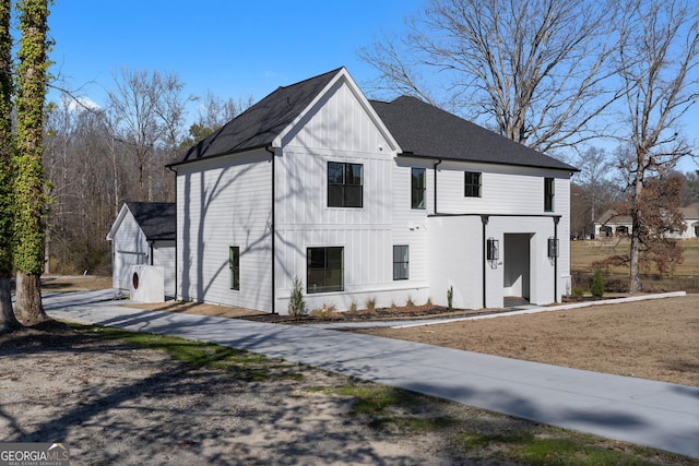 view of front of home with a shingled roof and board and batten siding