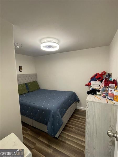 bedroom featuring baseboards and wood finished floors