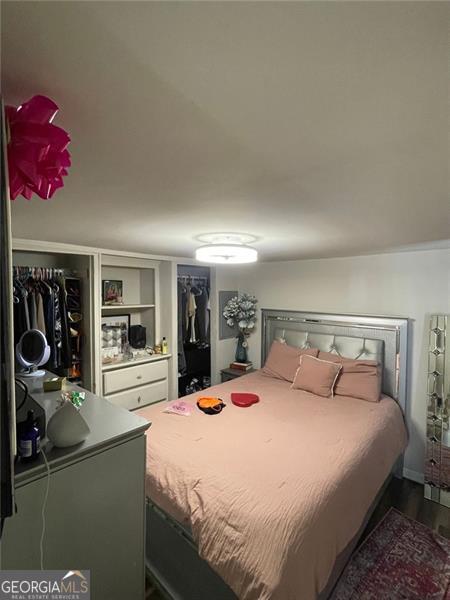 bedroom featuring dark wood-style flooring