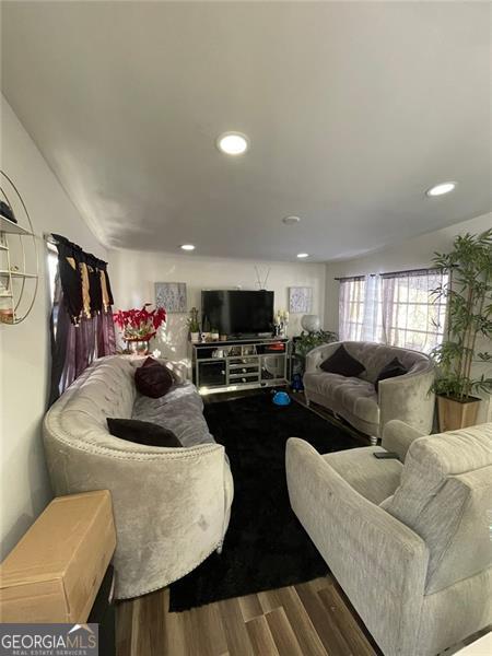 living room with wood finished floors and recessed lighting