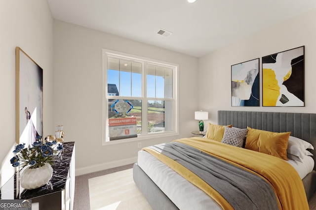 carpeted bedroom featuring visible vents and baseboards