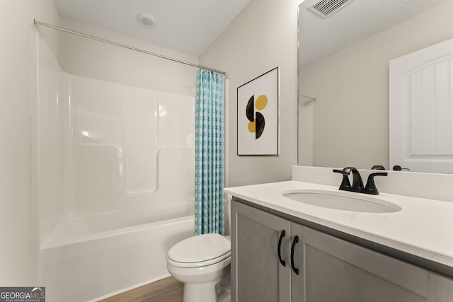 full bath featuring visible vents, toilet, shower / tub combo, vanity, and wood finished floors