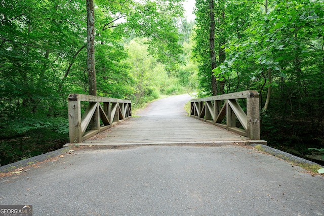 view of gate featuring a view of trees