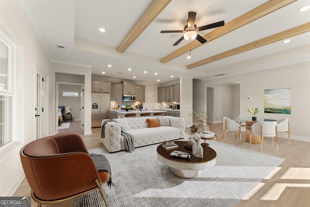 living room featuring light wood-style flooring, recessed lighting, visible vents, baseboards, and beam ceiling