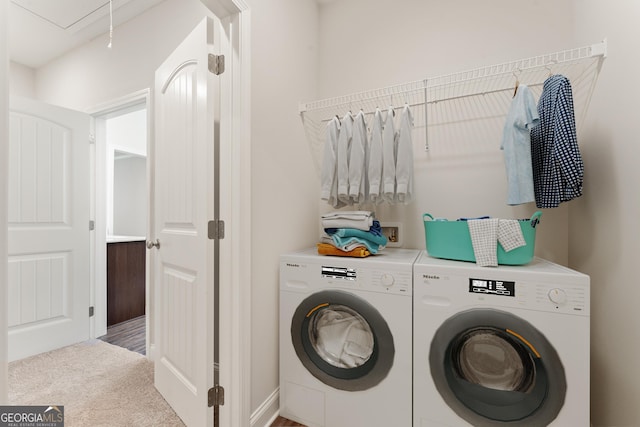 clothes washing area featuring laundry area, carpet, washing machine and clothes dryer, and attic access