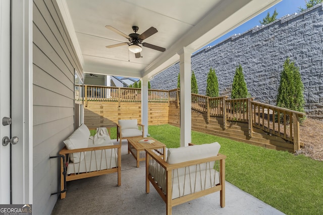 view of patio / terrace with ceiling fan, an outdoor living space, and fence