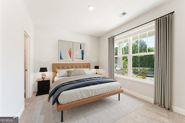 carpeted bedroom featuring visible vents and baseboards