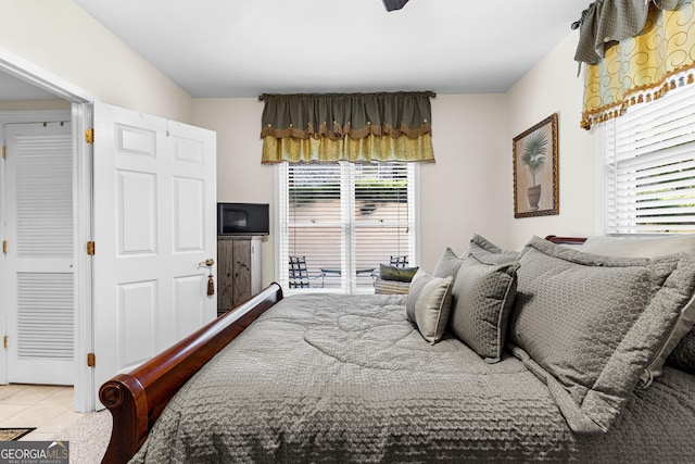 bedroom with access to exterior and tile patterned flooring