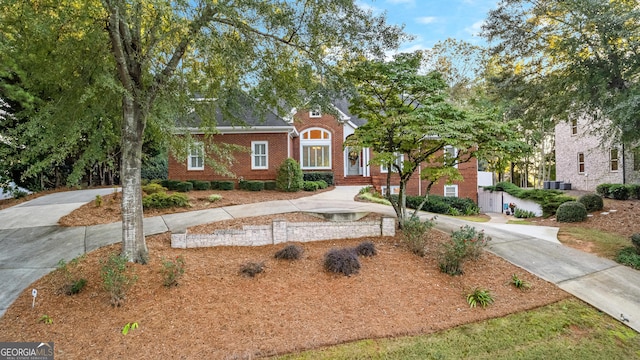 view of front facade with brick siding and driveway