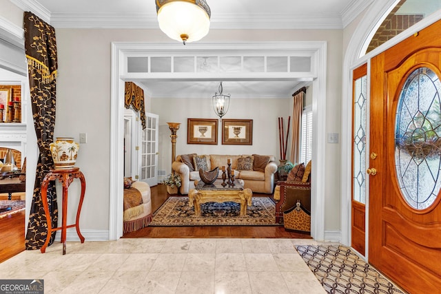 foyer entrance featuring baseboards, ornamental molding, and tile patterned floors