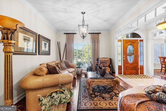 living area featuring a notable chandelier, crown molding, baseboards, and wood finished floors