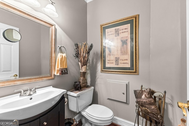 bathroom featuring toilet and vanity