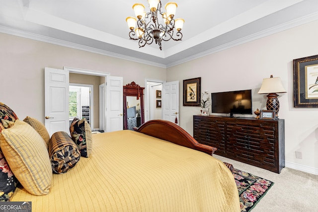 carpeted bedroom with an inviting chandelier, baseboards, and a tray ceiling