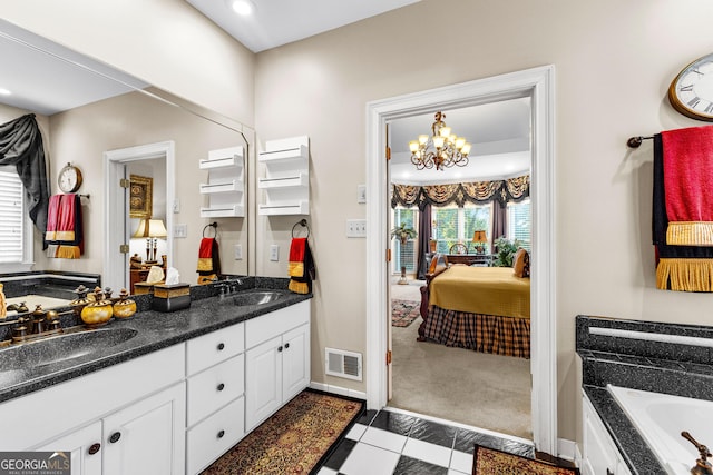 ensuite bathroom with a garden tub, visible vents, a sink, and ensuite bathroom