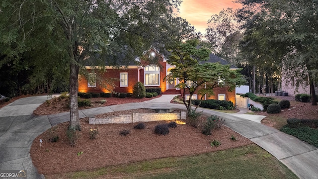 view of front of house featuring brick siding and driveway