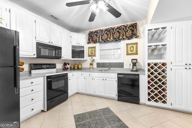 kitchen featuring light tile patterned floors, visible vents, black appliances, white cabinetry, and a sink