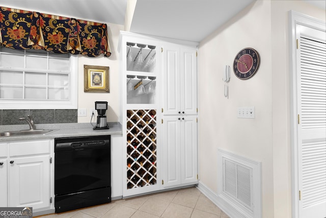 bar featuring light tile patterned floors, black dishwasher, visible vents, and a sink