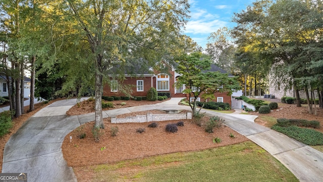 obstructed view of property featuring driveway and brick siding