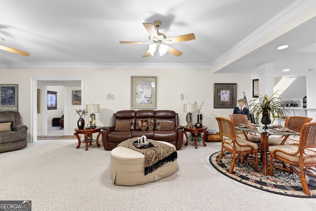 carpeted living room with ornamental molding, a ceiling fan, and ornate columns