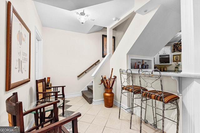 staircase with tile patterned flooring and baseboards