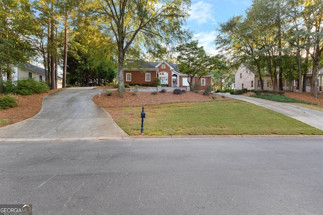 view of front of home with a front yard and driveway