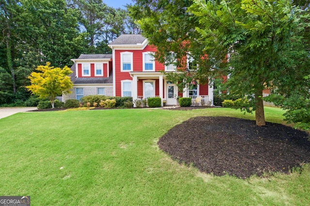 view of front of home with a porch and a front yard