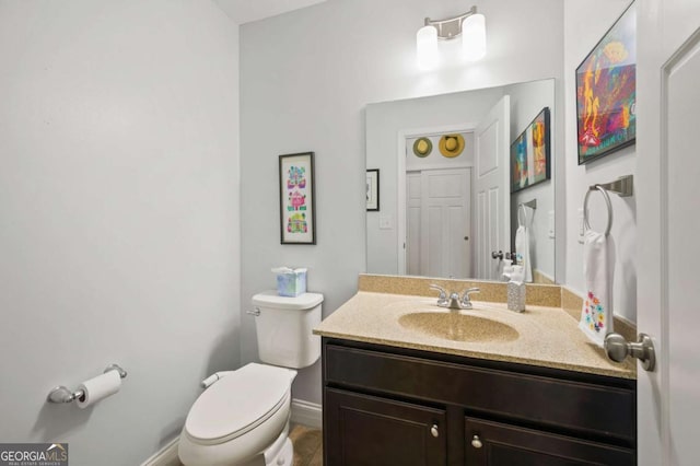 bathroom featuring toilet and vanity