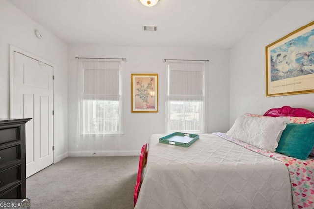 carpeted bedroom with visible vents and baseboards