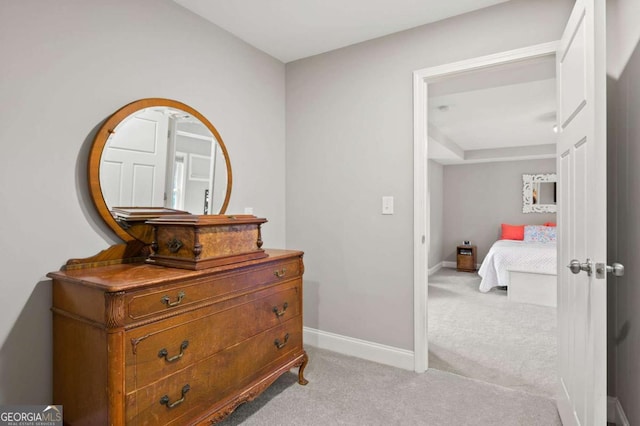 bedroom with baseboards and light colored carpet