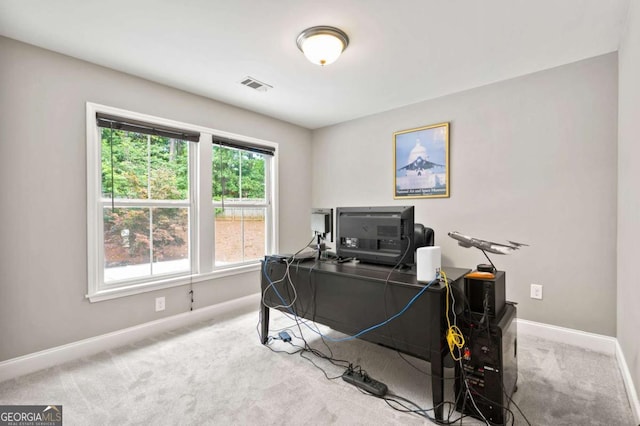 carpeted office featuring visible vents and baseboards