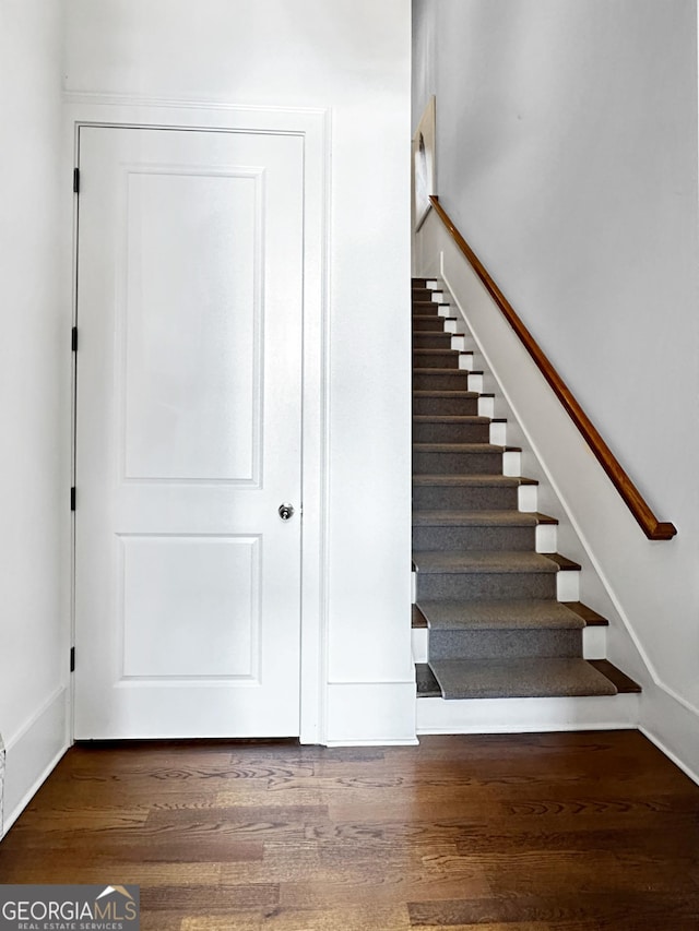 staircase featuring wood finished floors