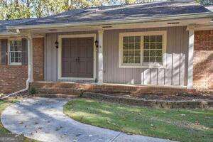 entrance to property featuring brick siding