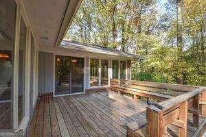 wooden deck featuring a sunroom