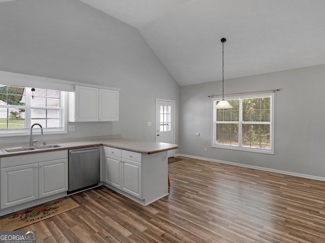 kitchen featuring dark wood finished floors, white cabinets, a peninsula, stainless steel dishwasher, and a sink