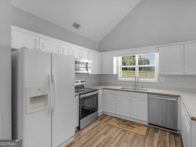 kitchen featuring stainless steel appliances, visible vents, a sink, and white cabinetry